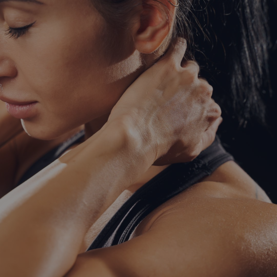 woman holding her hand to her sore neck